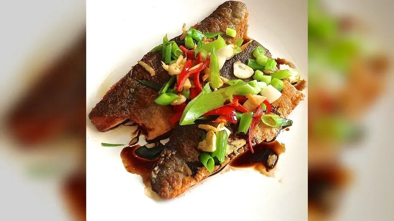 Sea bass with sizzled ginger, chilli & spring onions
